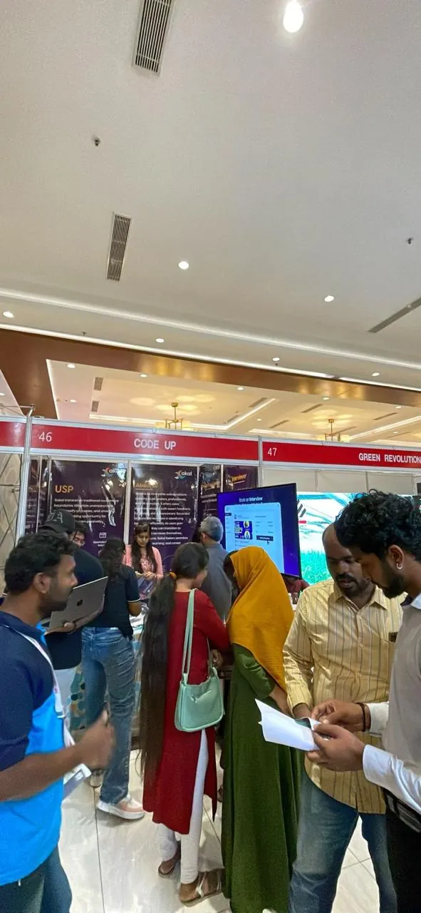 Visitors read Xakal brochures in front of the stall screen