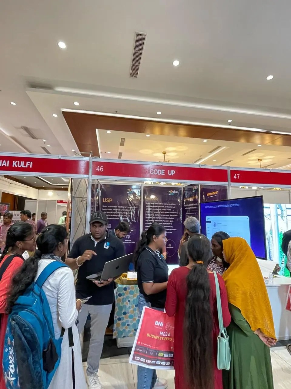 A Xakal team member walks students through the platform on a laptop