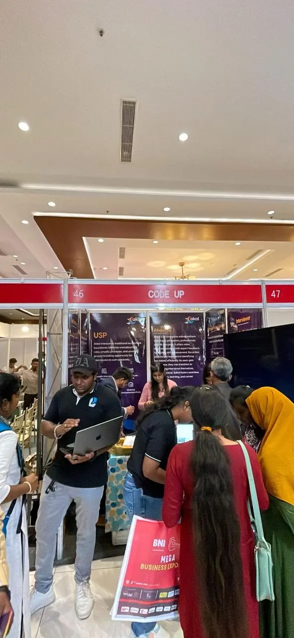 The Xakal stall with banners and a screen, busy with visitors