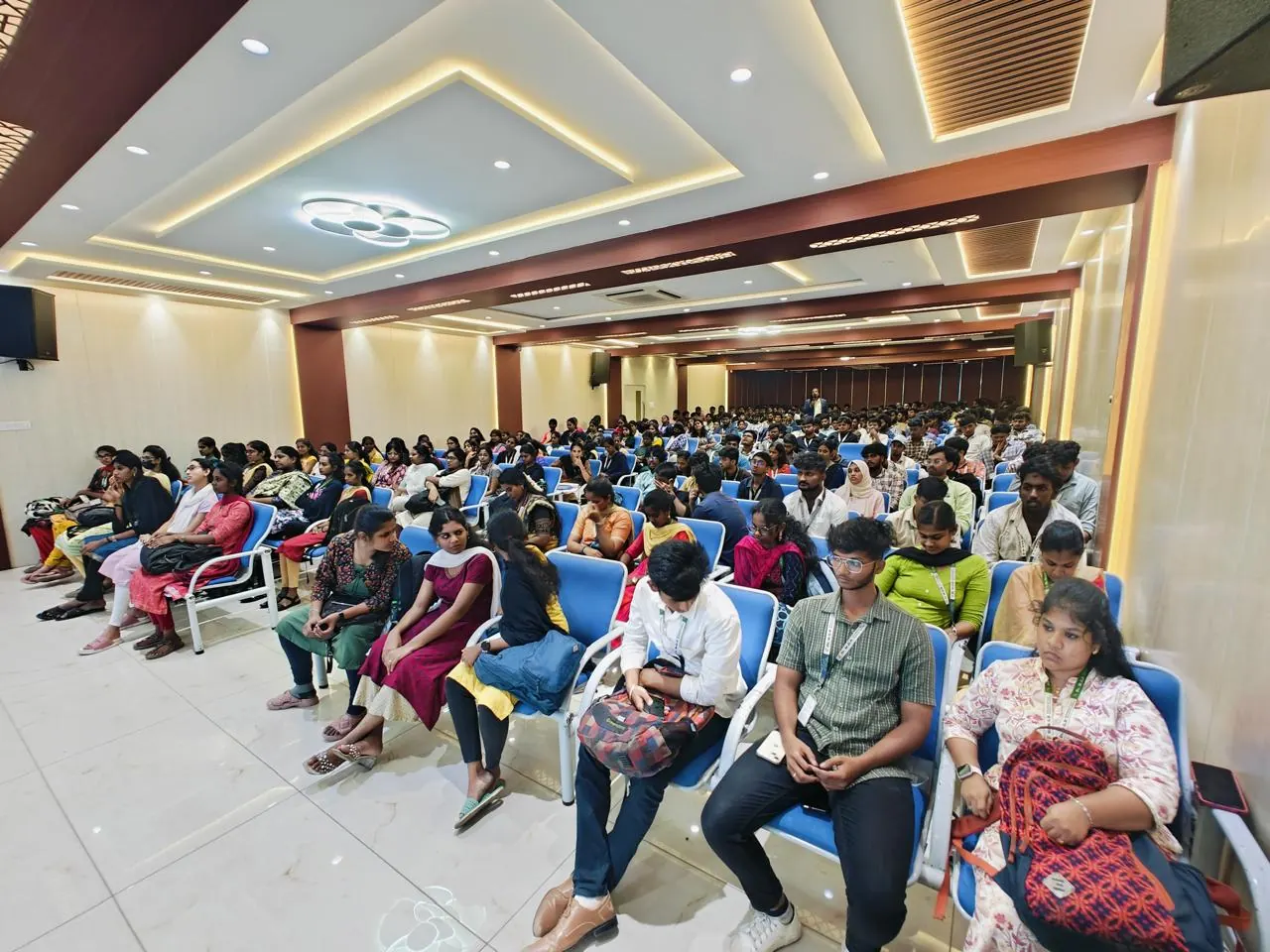 A full auditorium of students at Dr. M.G.R. Educational and Research Institute