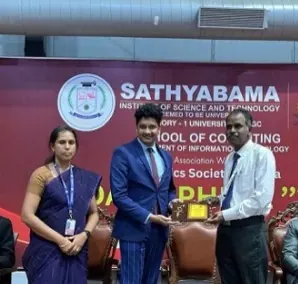 Xakal receives a memento on stage at Sathyabama Institute of Science and Technology
