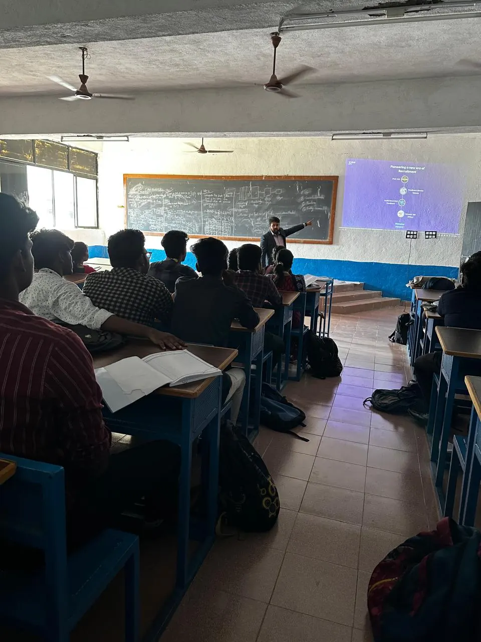 A Xakal speaker points to a slide about a new era of recruitment