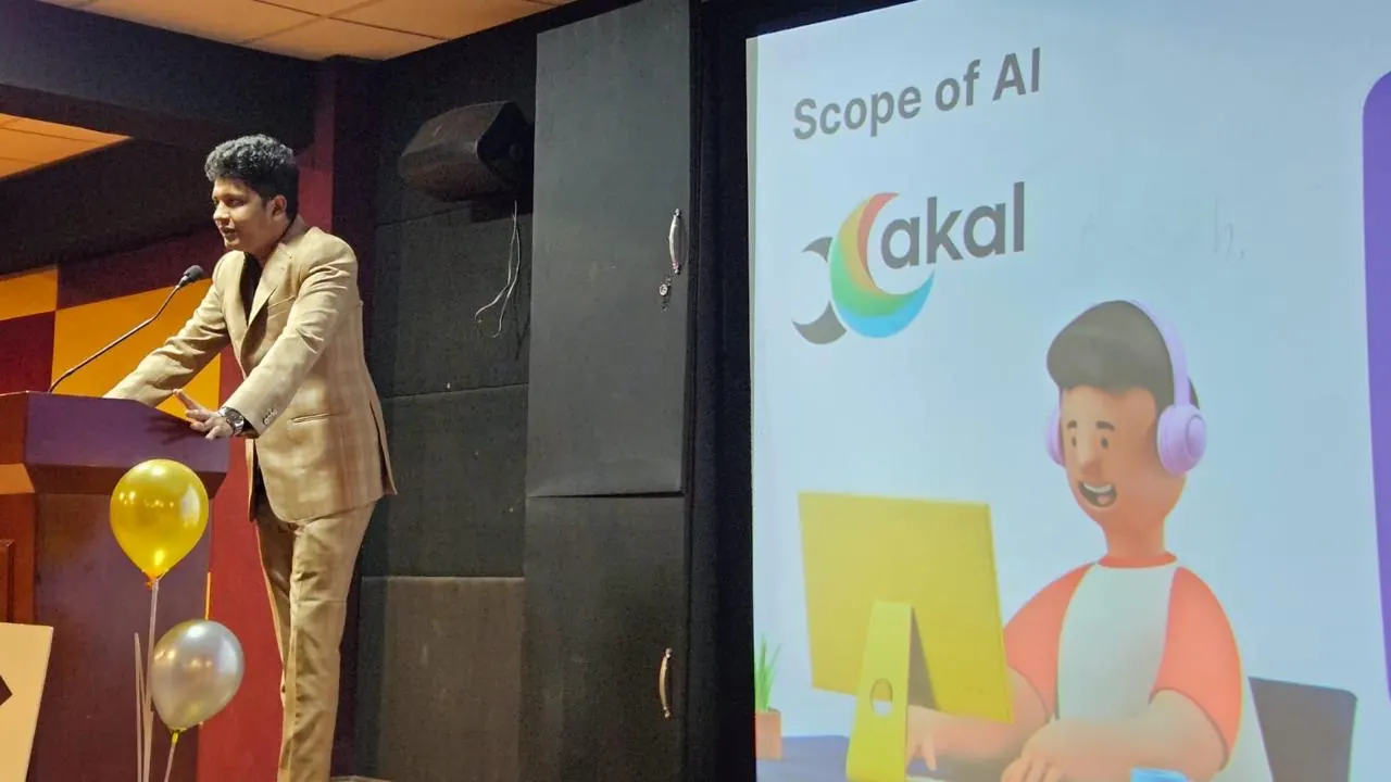 R. Aravind Kumaran speaks at the podium beside a Xakal slide