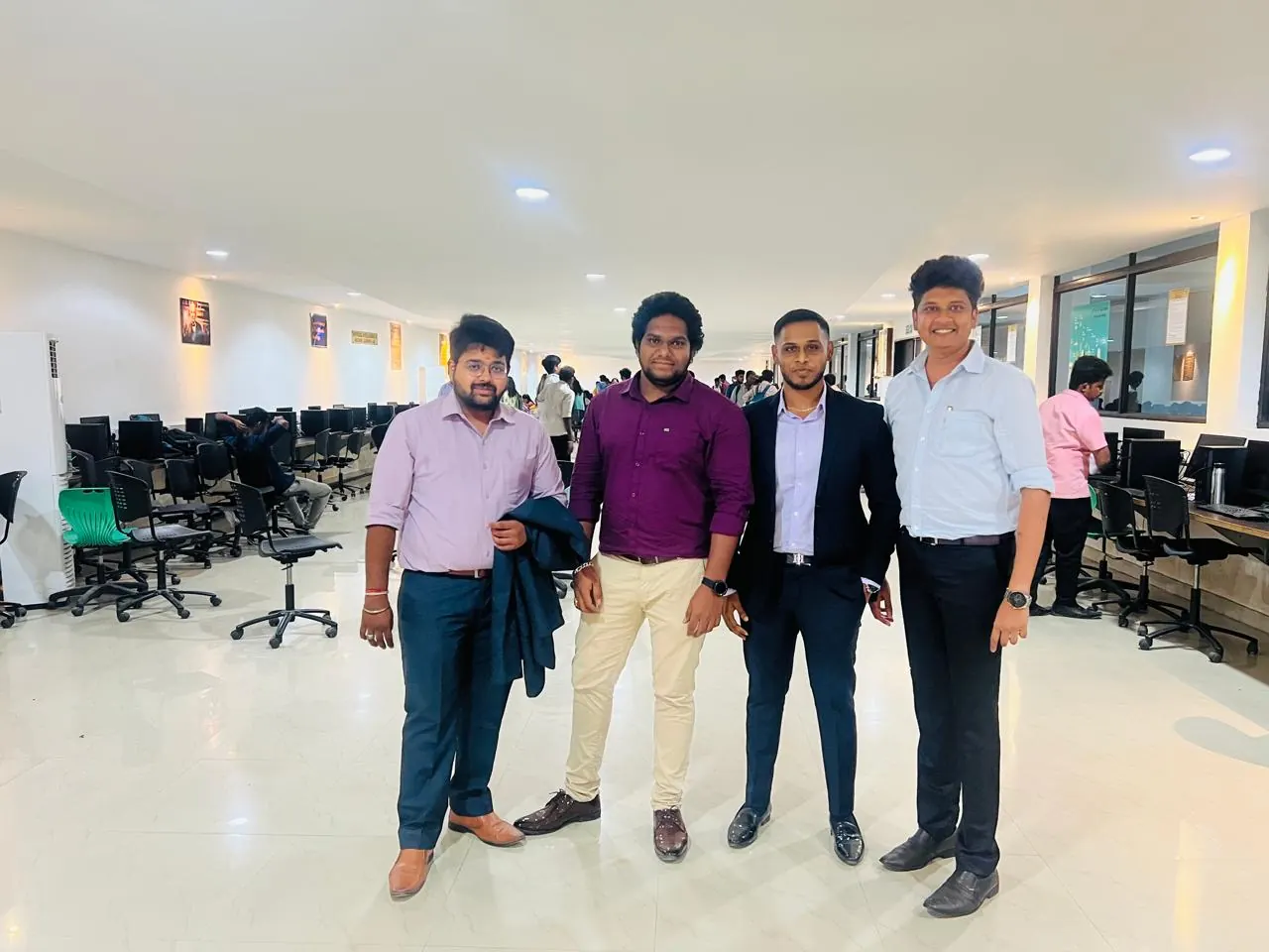 Four members of the Xakal team standing in a college computer lab