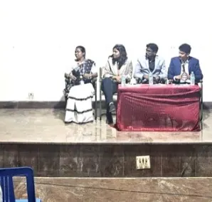 Xakal on a jury panel on stage at St. Peter's